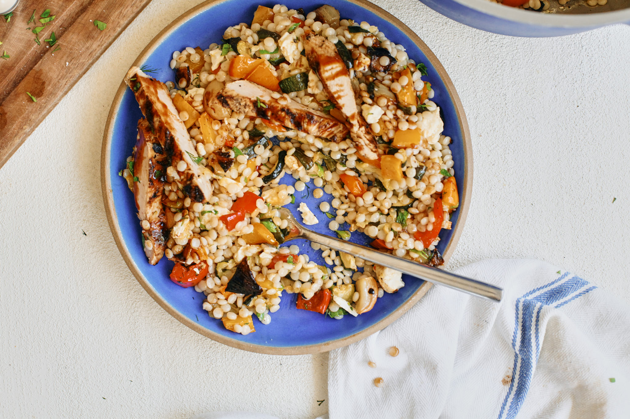 mediterranean pearl couscous topped with grilled chicken and balsamic
