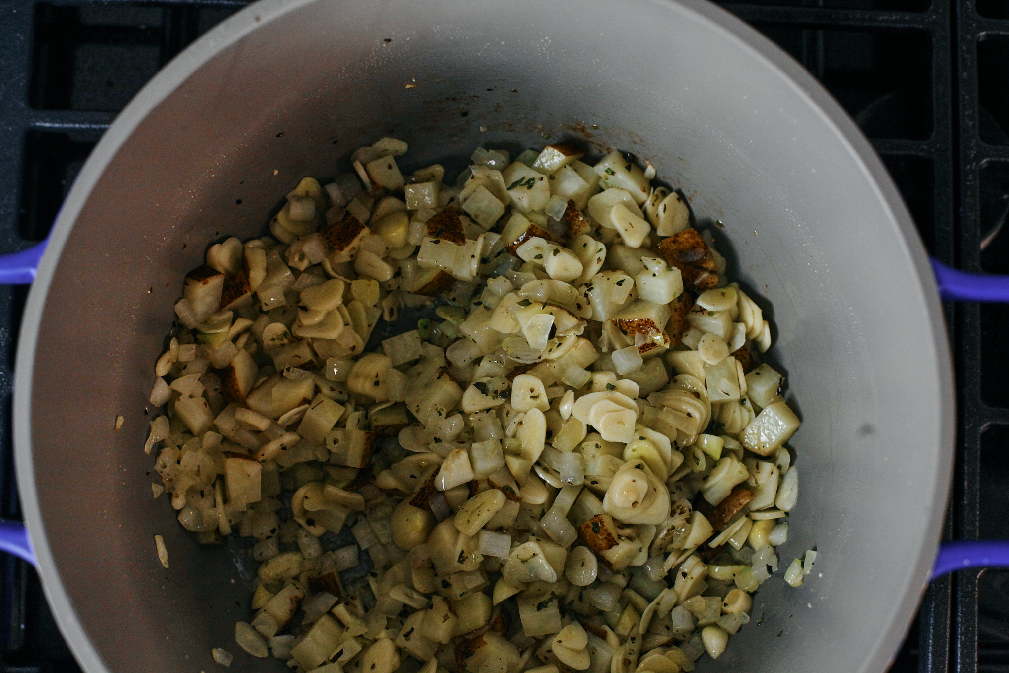 garlic, onion and seasonings sautéeing over the stove for the garlic soup