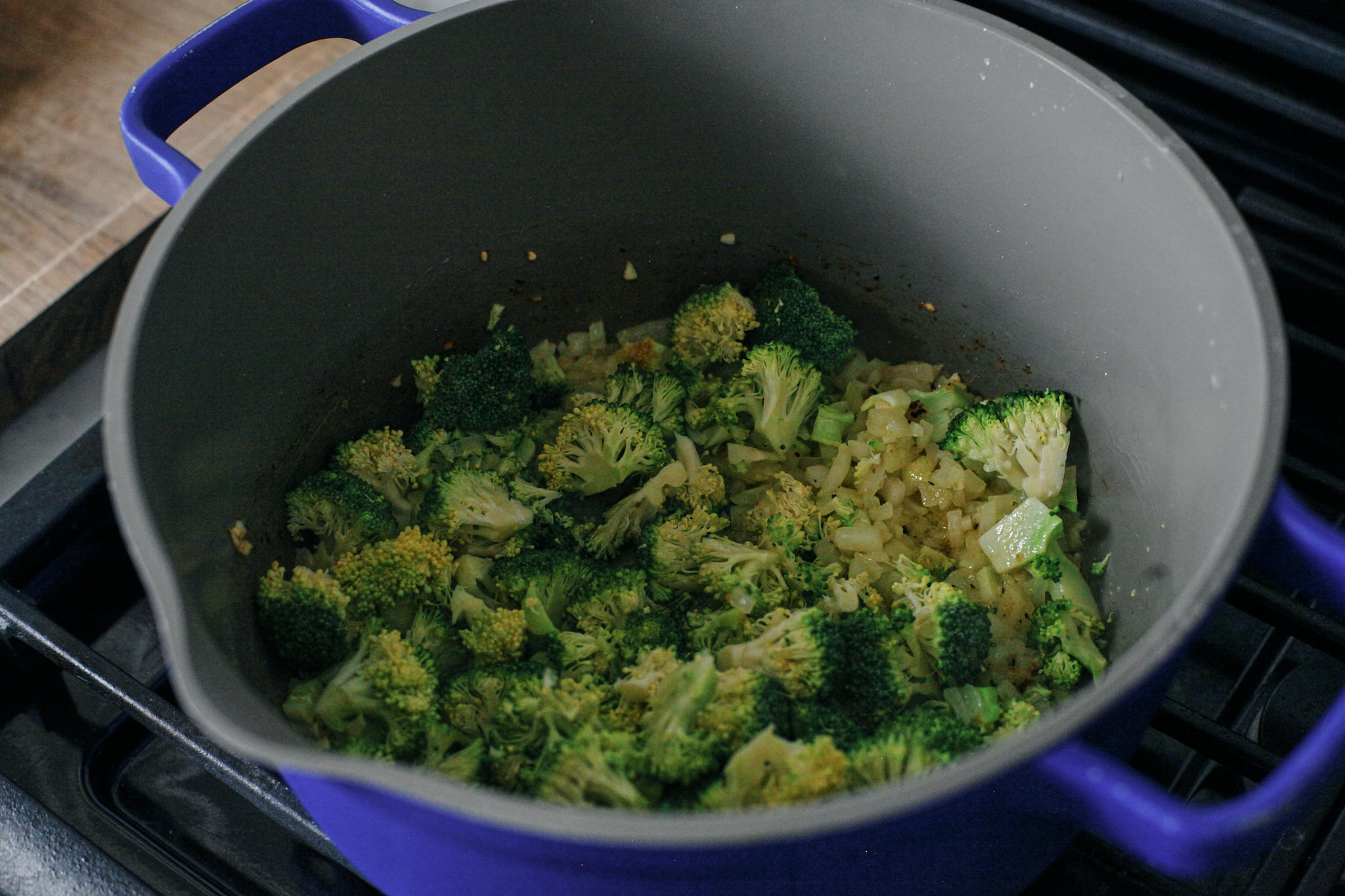 broccoli, onions, garlic and seasonings sautéeing in a pot