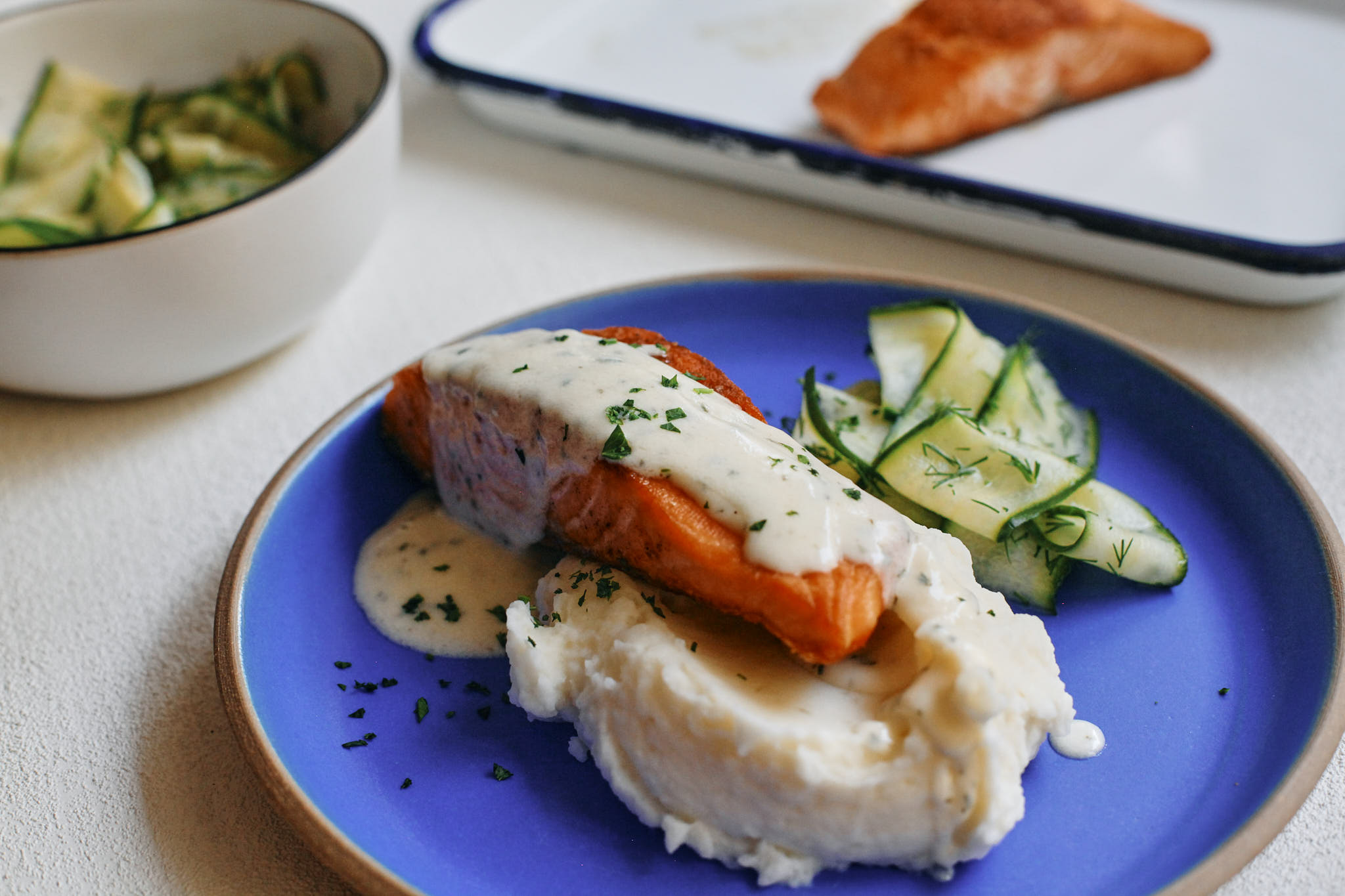 salmon with Norwegian butter sauce, mashed potatoes and pickled Norwegian cucumber salad