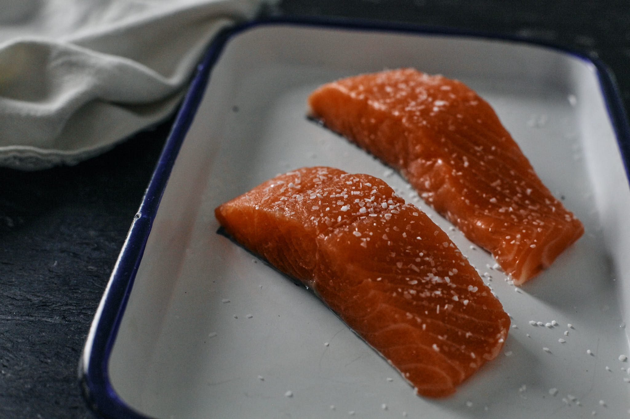 raw salmon filets seasoned with salt