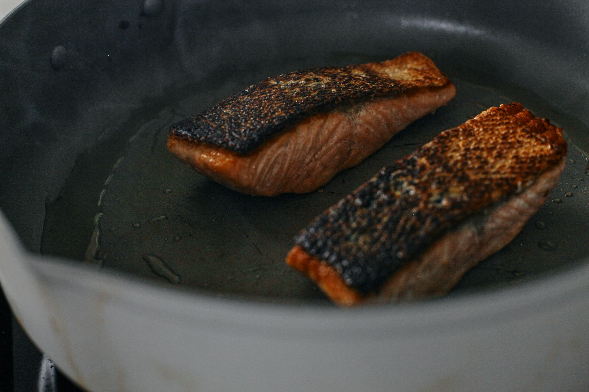 salmon searing in a pan