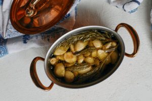 garlic confit with rosemary and sage softened and bubbly
