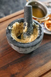 mashed garlic confit in a mortar and pestle