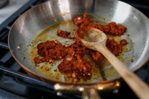 tomato paste cooking in the sautee pan
