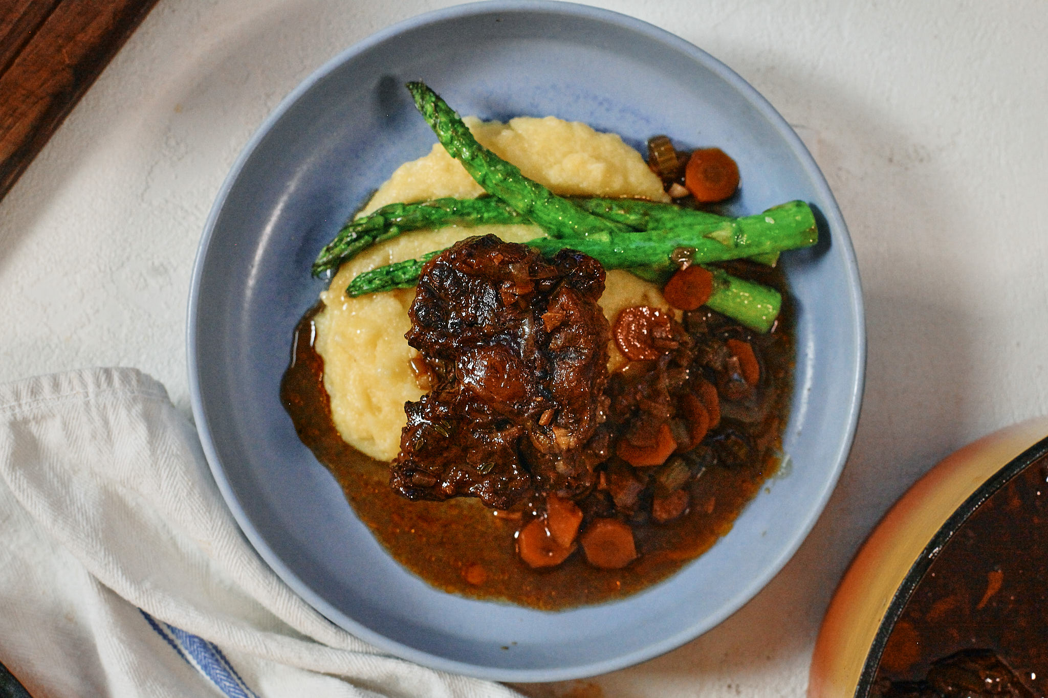 braised oxtail over polenta with asparagus