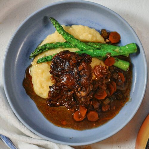 braised oxtail over a bed of polenta with asparagus
