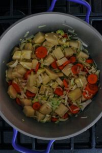 carrots, potato and leek sauteeing in a pot