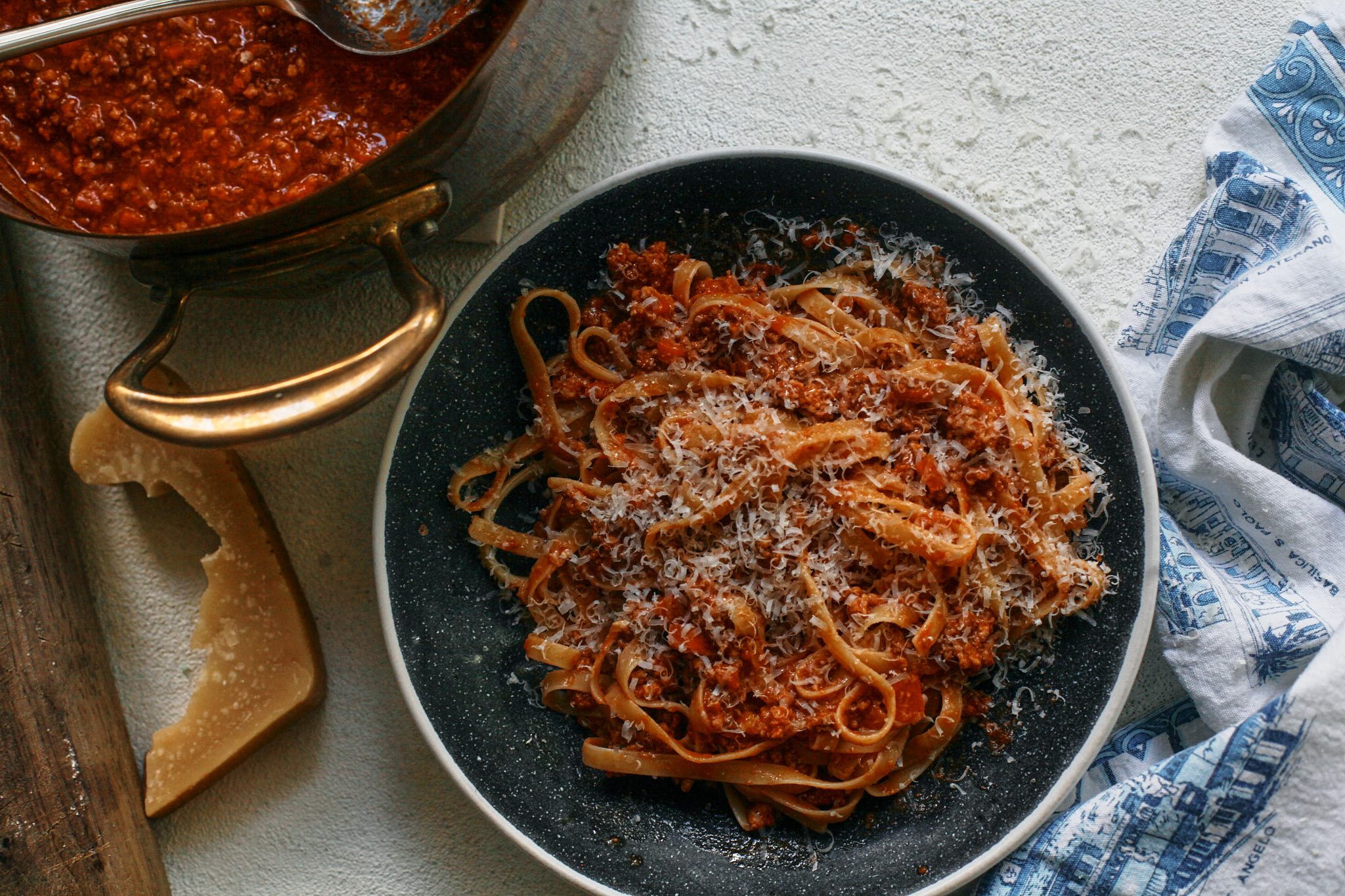 fettuccine bolognese with parmesan on top
