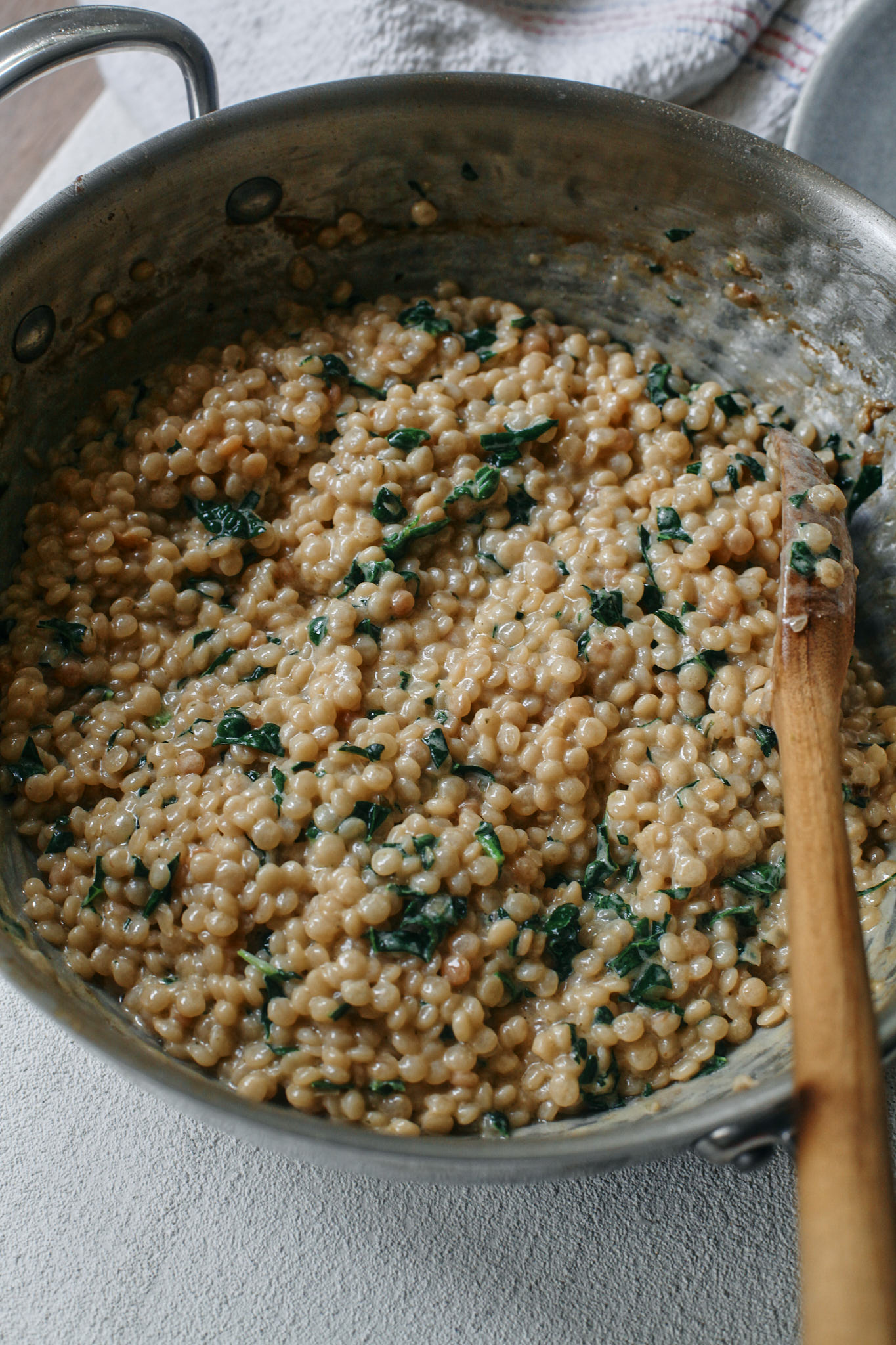 creamy pearl couscous with chopped kale