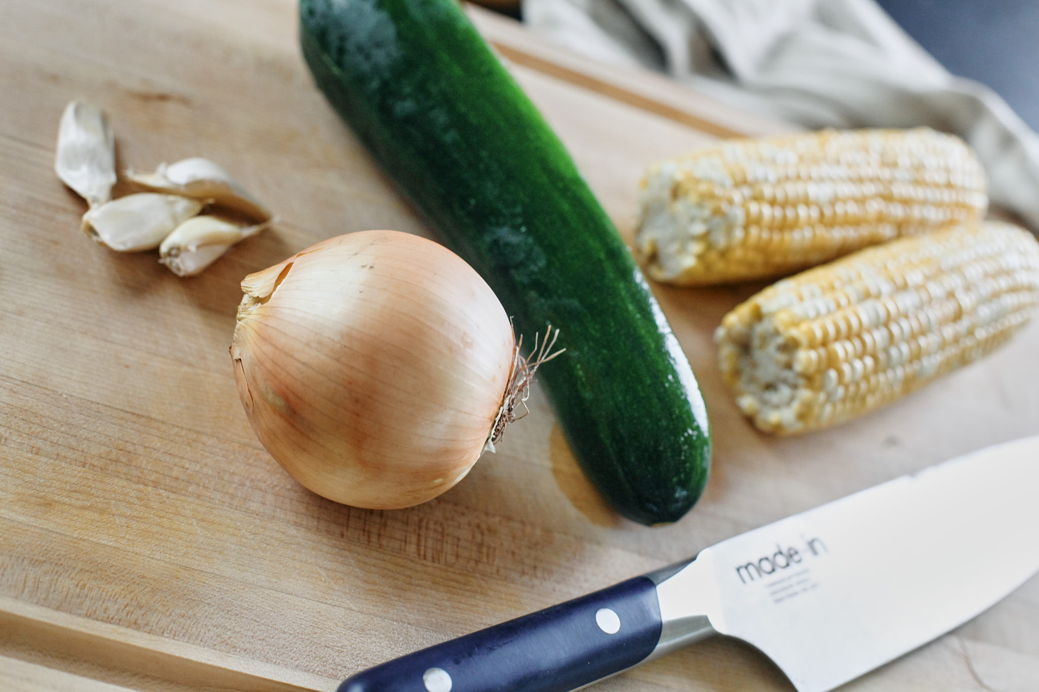 4 cloves of garlic, yellow onion, zucchini, two fresh corn on the cob