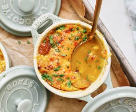 crocks of golden garlic soup after being broiled