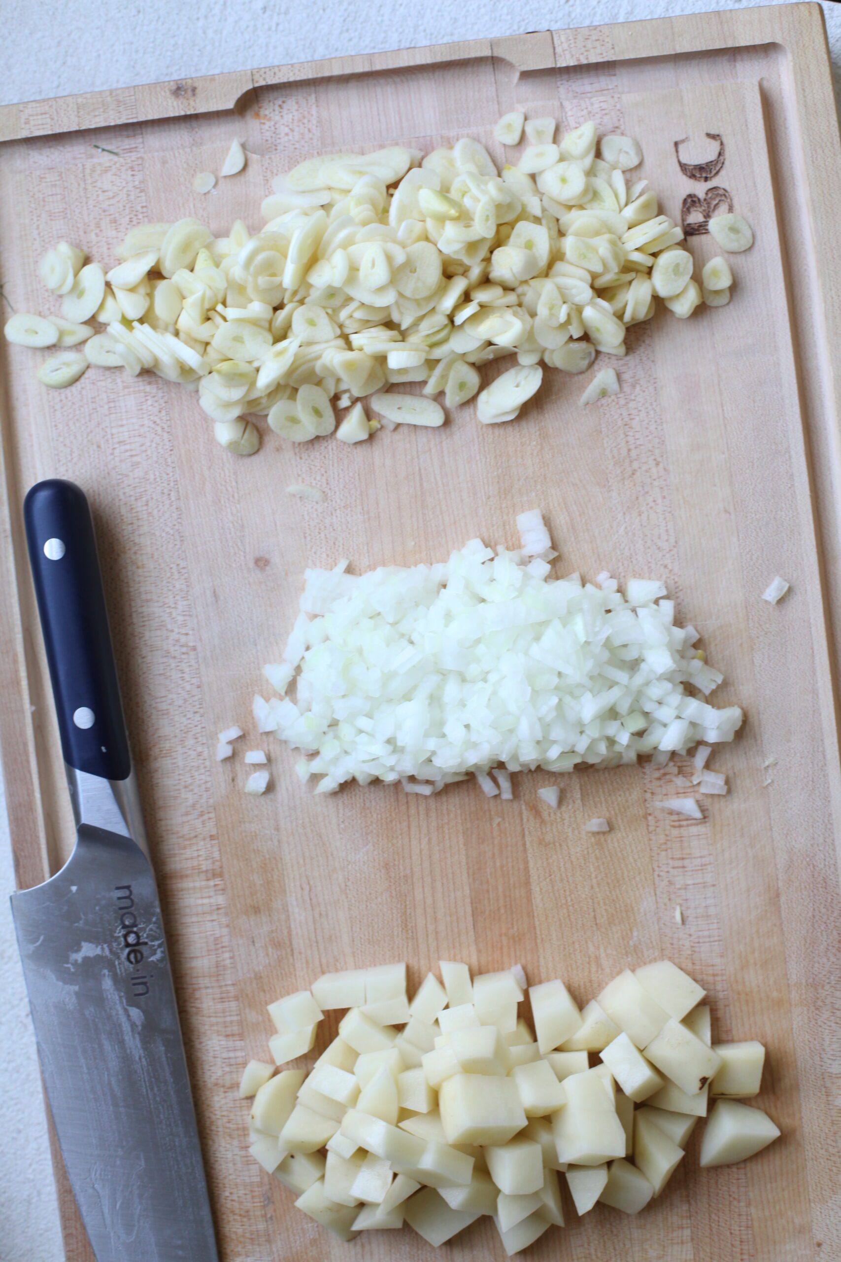 prep for the golden garlic soup: chopped potato, chopped onion, and sliced garlic