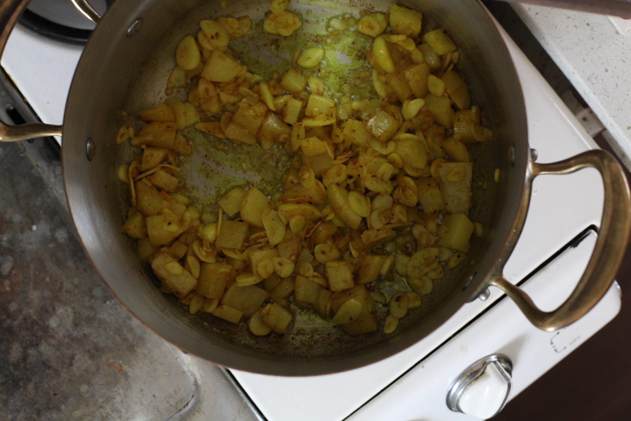 onion, garlic, potato sautéing with turmeric