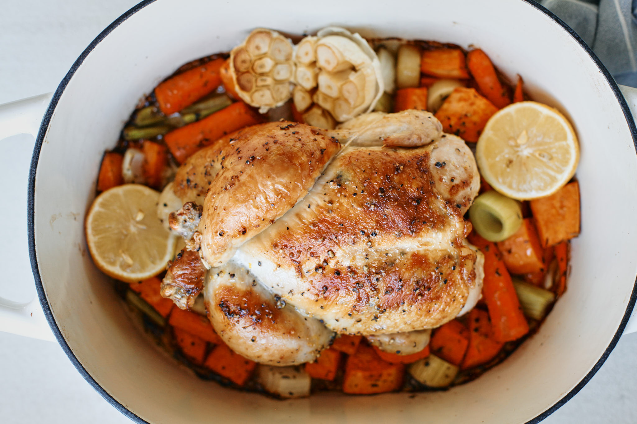 cooked one pot lemon pepper chicken in the pot with vegetables underneath