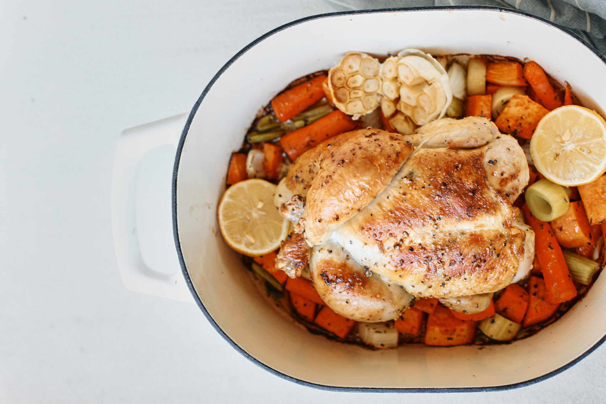 cooked one pot lemon pepper chicken in the pot with vegetables underneath