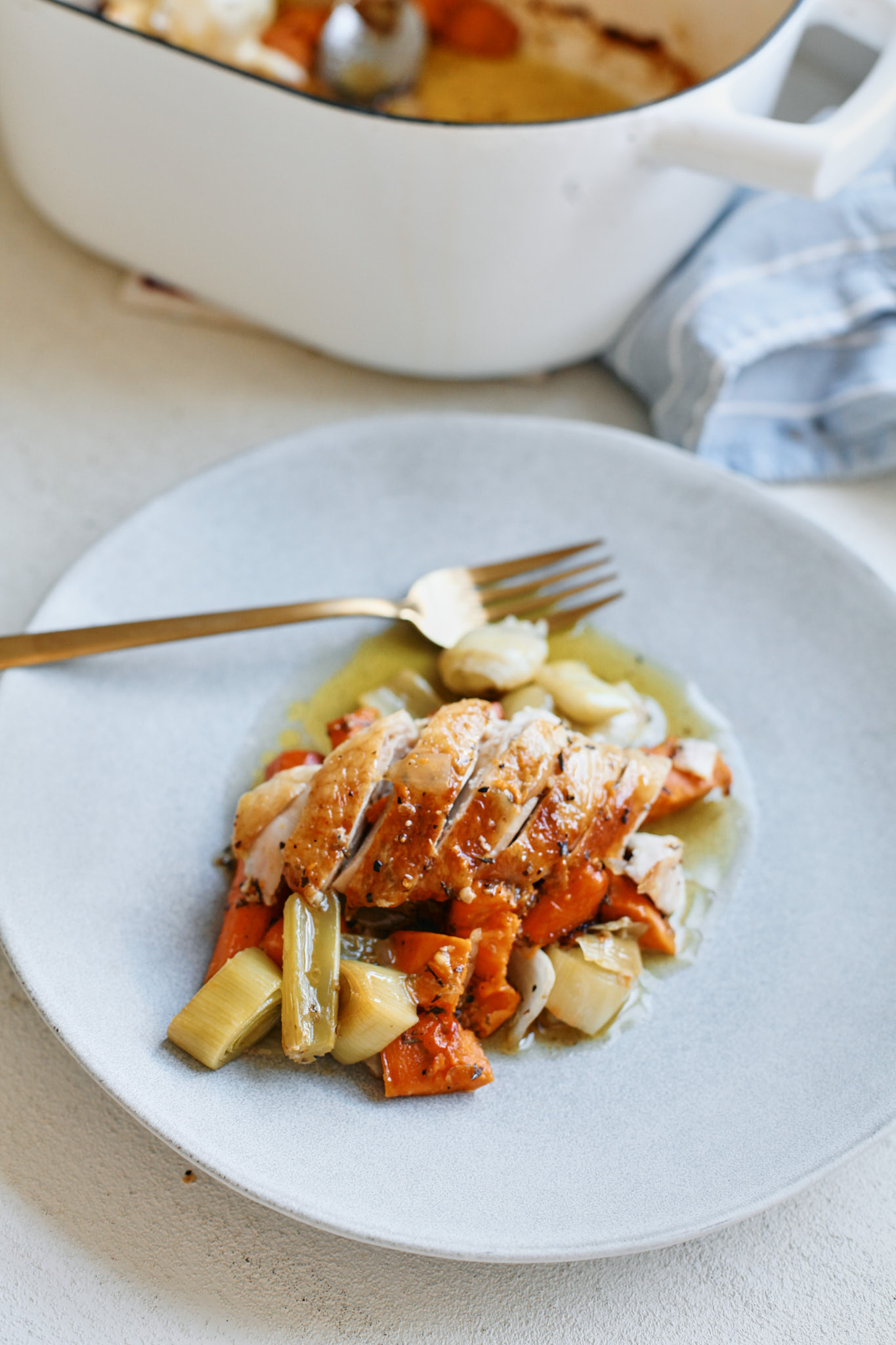 lemon pepper chicken served over a bed of roasted vegetables