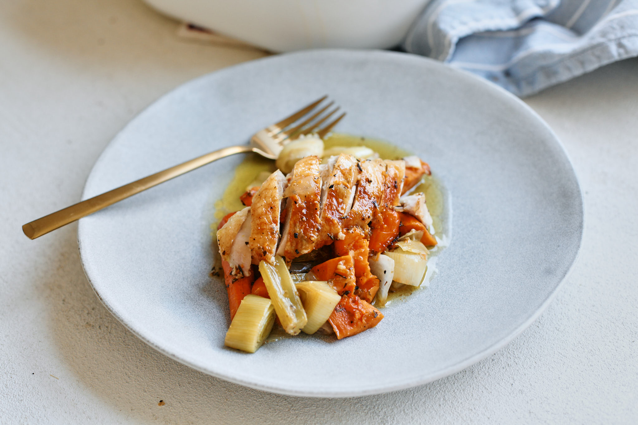 lemon pepper chicken served over a bed of roasted vegetables