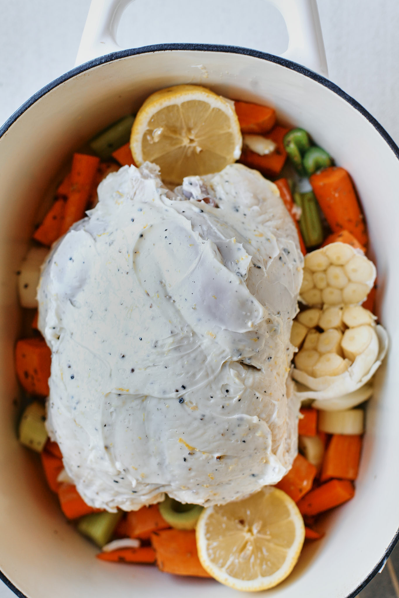 one pot lemon pepper chicken in the pot with vegetables underneath