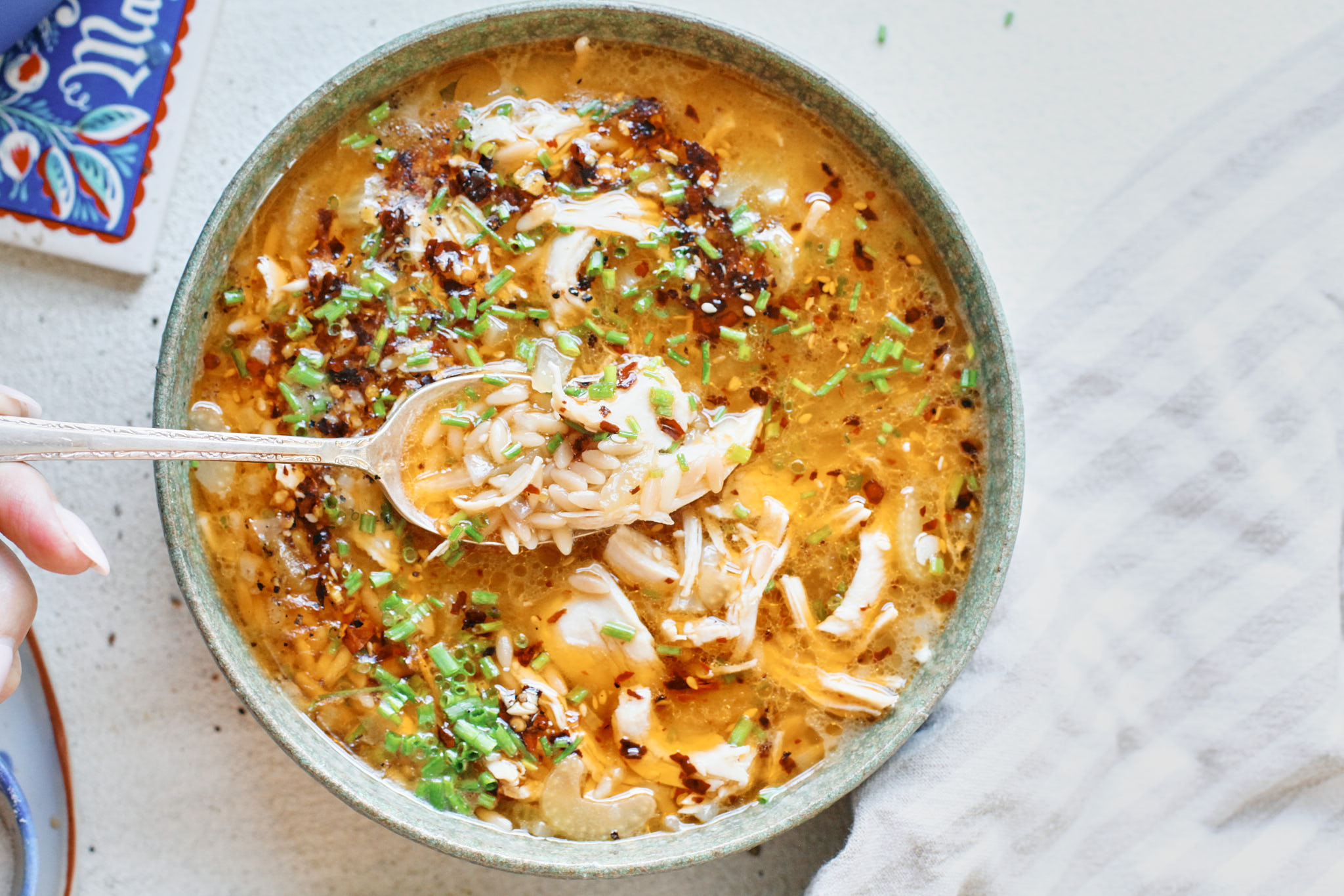 toasted orzo chicken soup with chili crisp on top