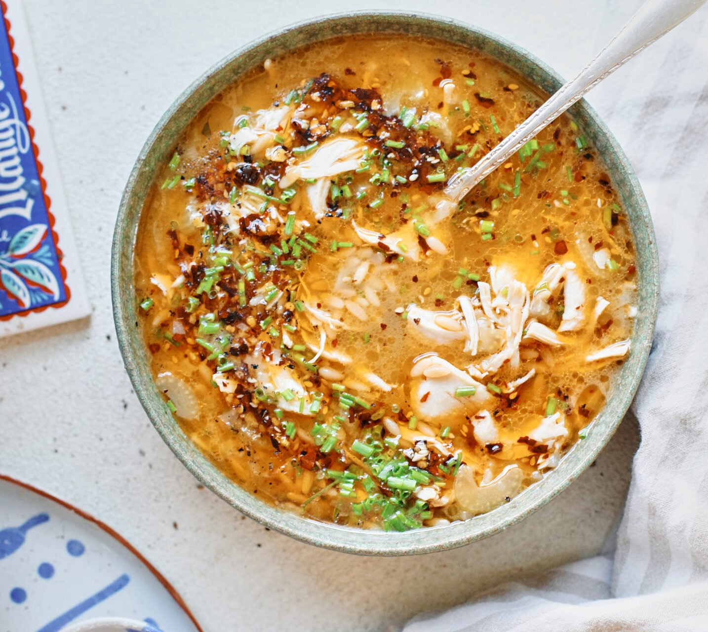 toasted orzo chicken soup with chili crisp on top