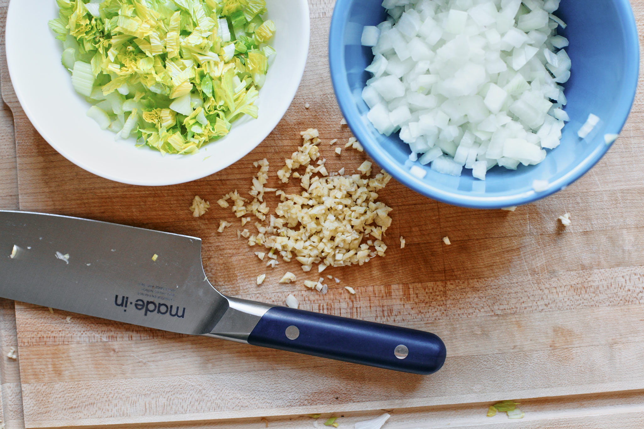 chopped celery, celery leaves, onion and garlic for making Creamy Tomato Ravioli Soup