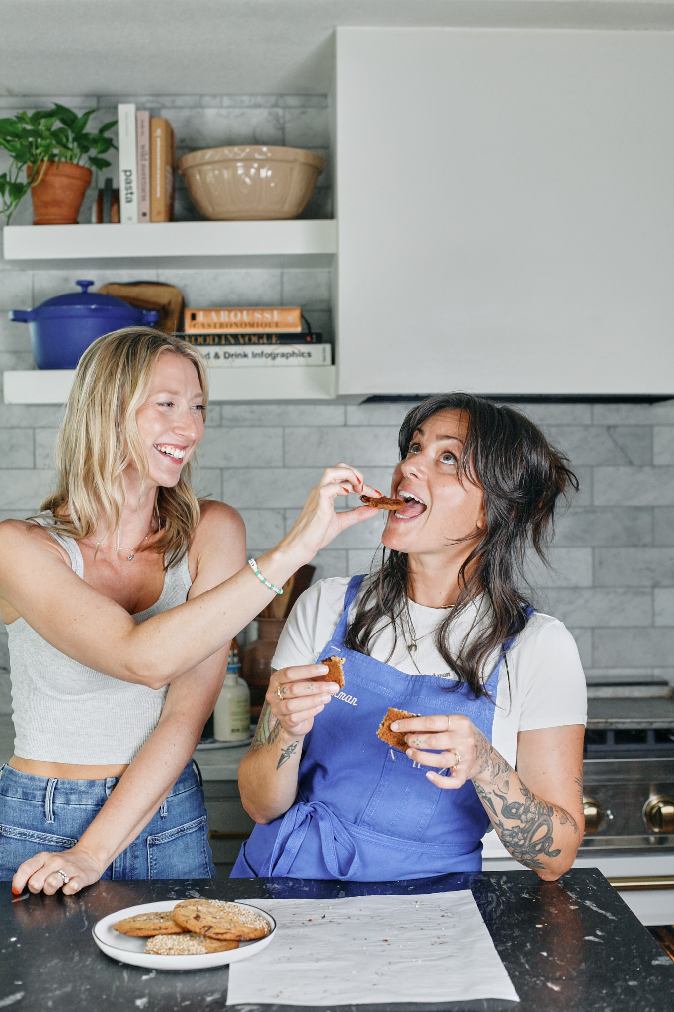 brita and amanda rockman trying the cookies and goofing off in the kitchen