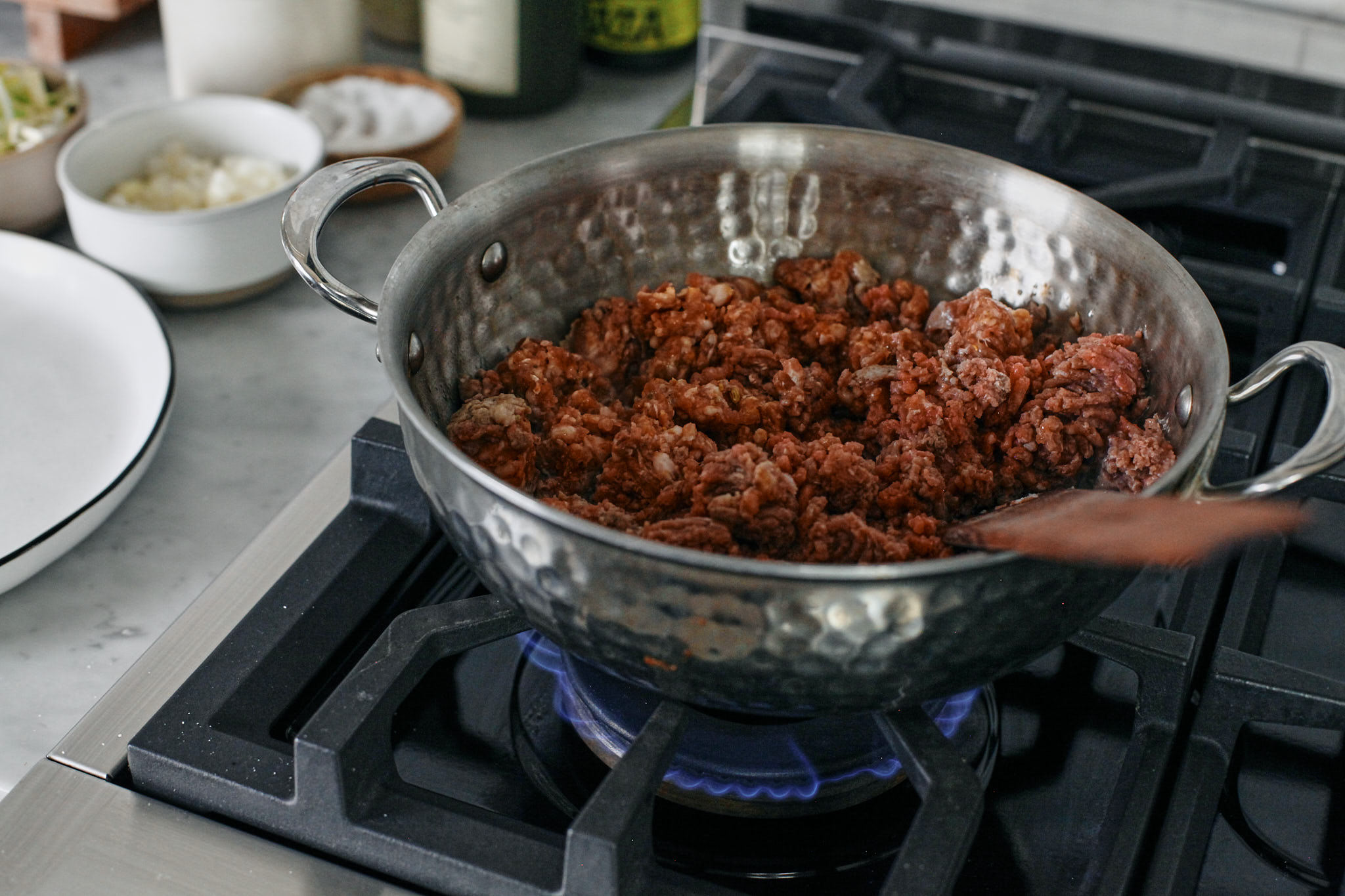 italian sausage and ground beef browning on the stove