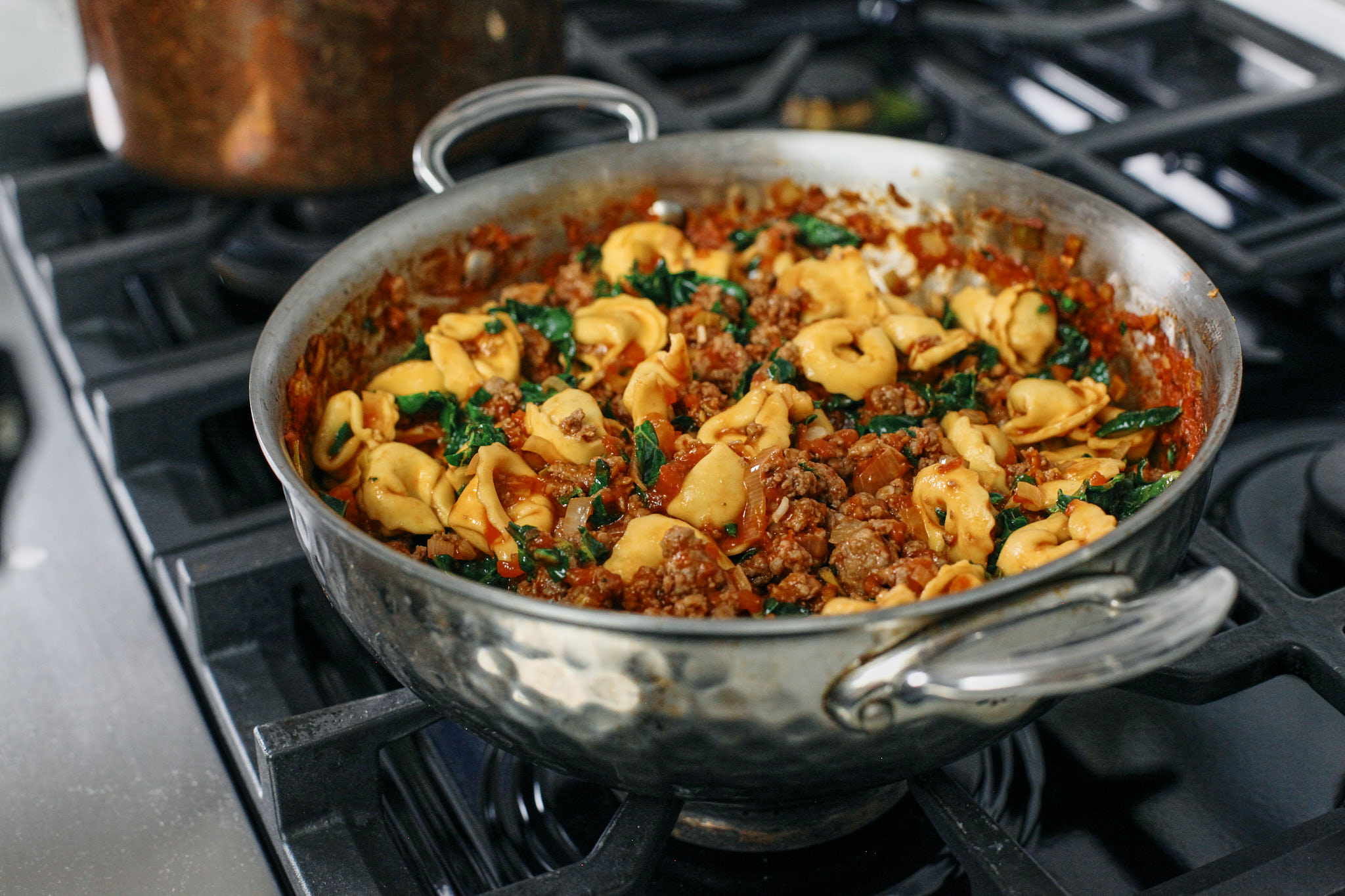 creamy tuscan tortellini bake coming together