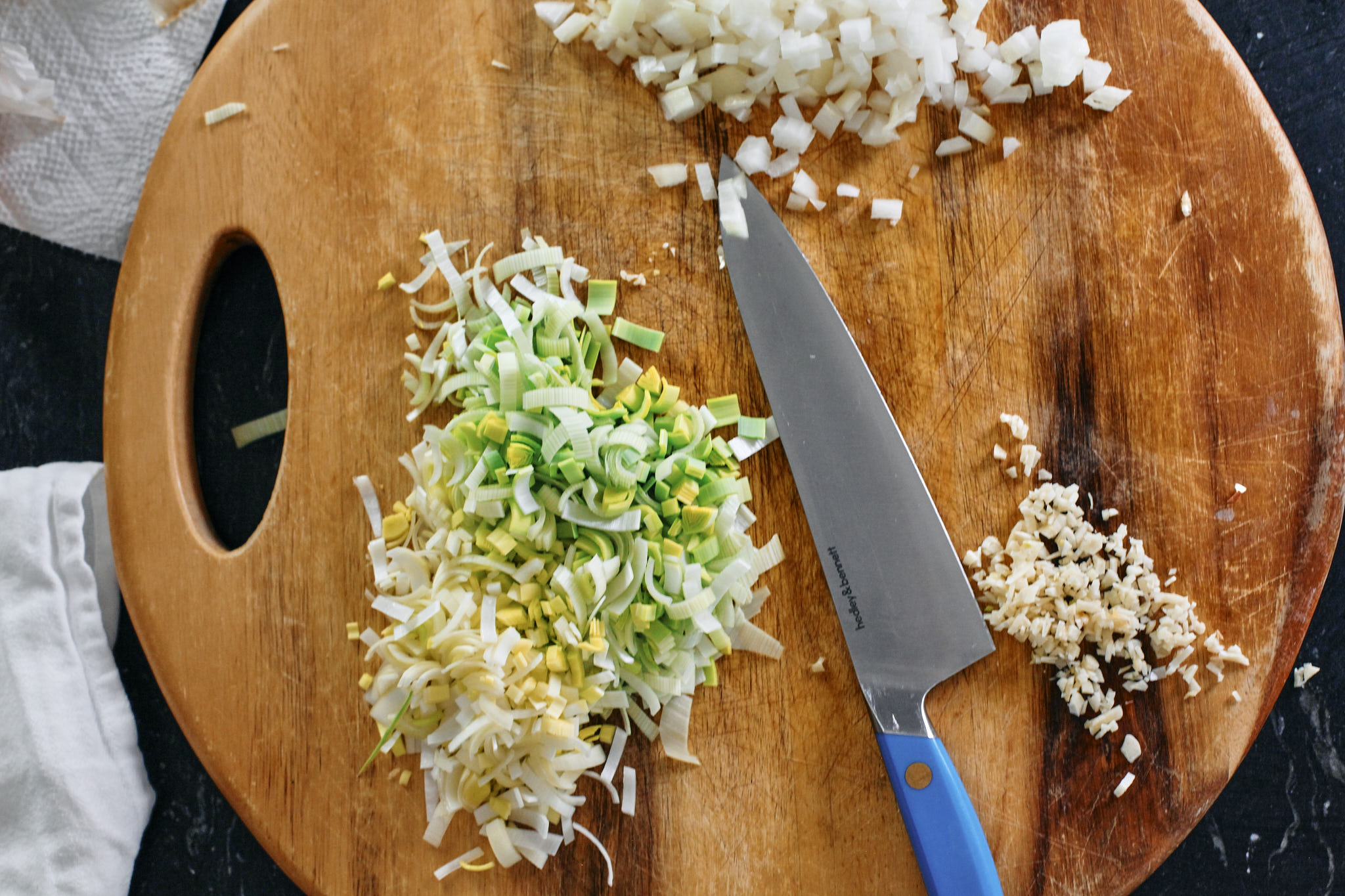 prep for creamy tuscan tortellini bake - chopped leek, onion and garlic