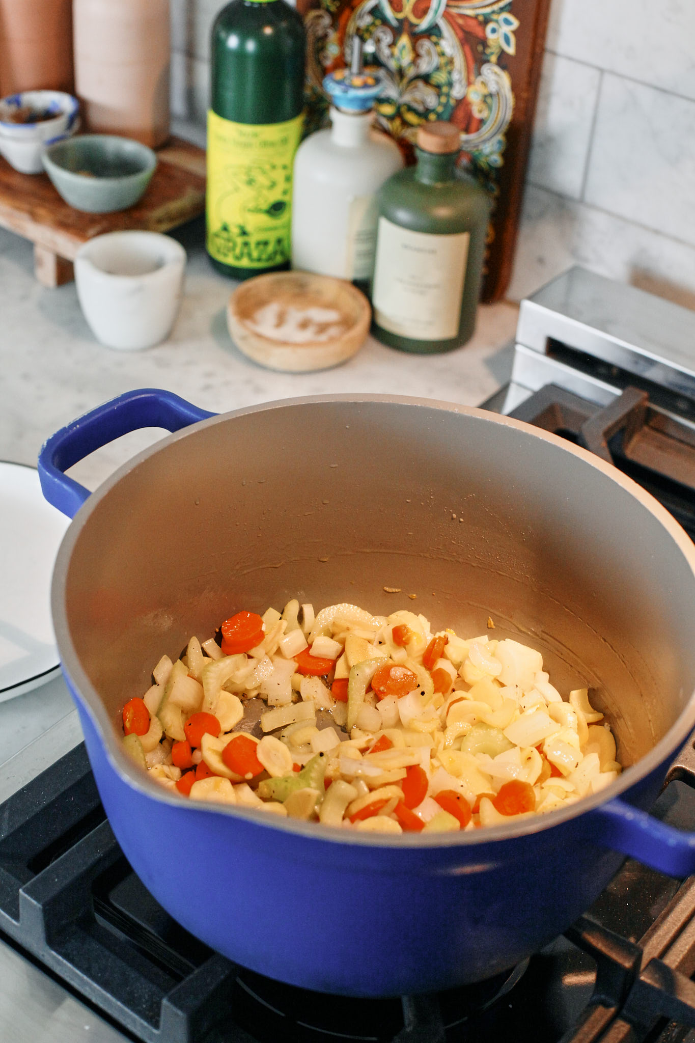 prep for the creamy tortellini vegetable soup: chopped celery, carrots, parsnip, onion and garlic all sautéeing in a pot with olive oil and butter