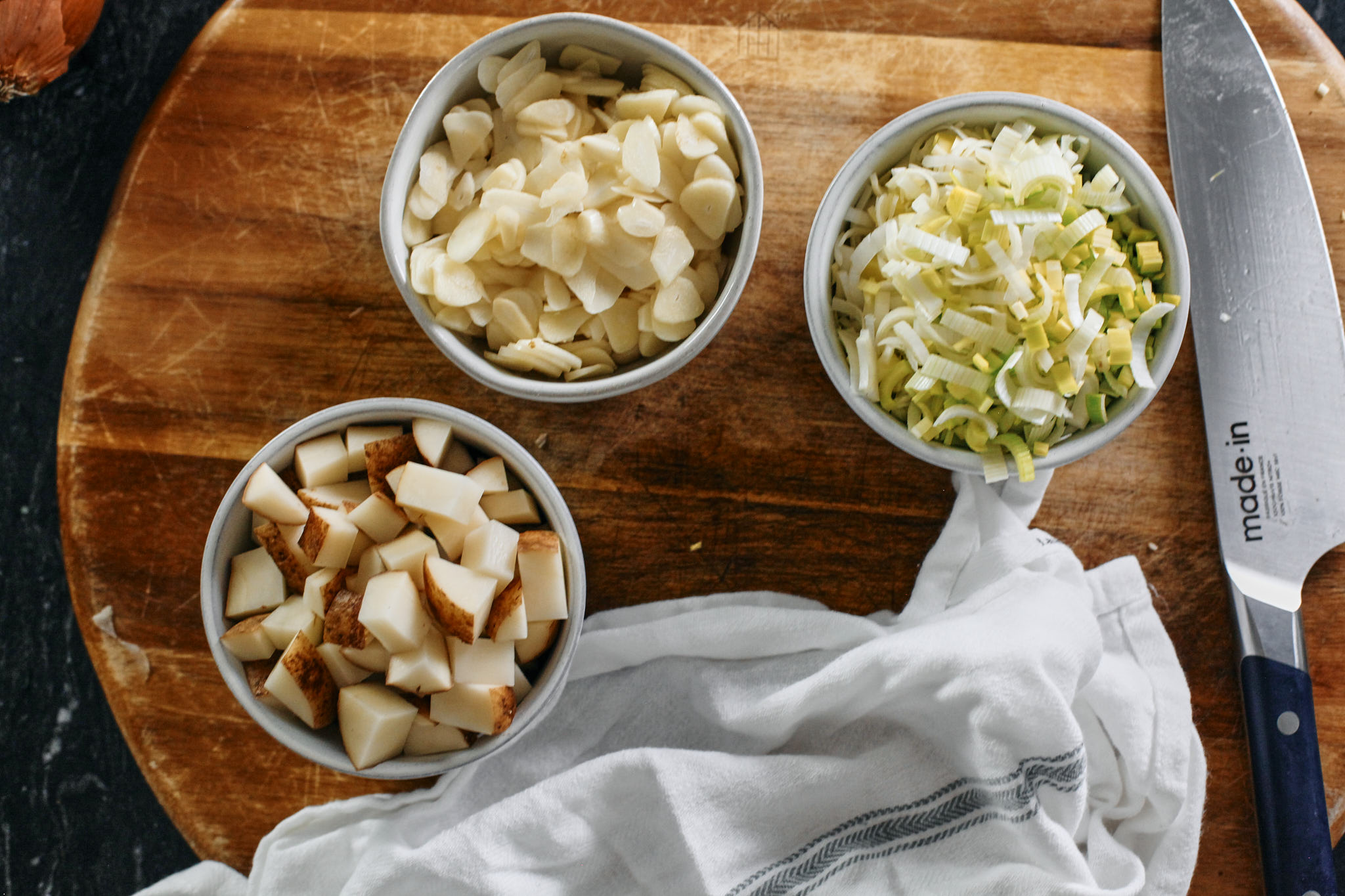 prep for the mighty greens garlic soup - chopped potato, sliced garlic, and chopped leek.