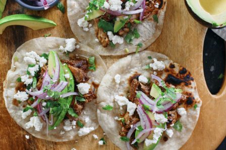 citrus braised pulled pork tacos with avocado, pickled onions, cilantro, queso fresco