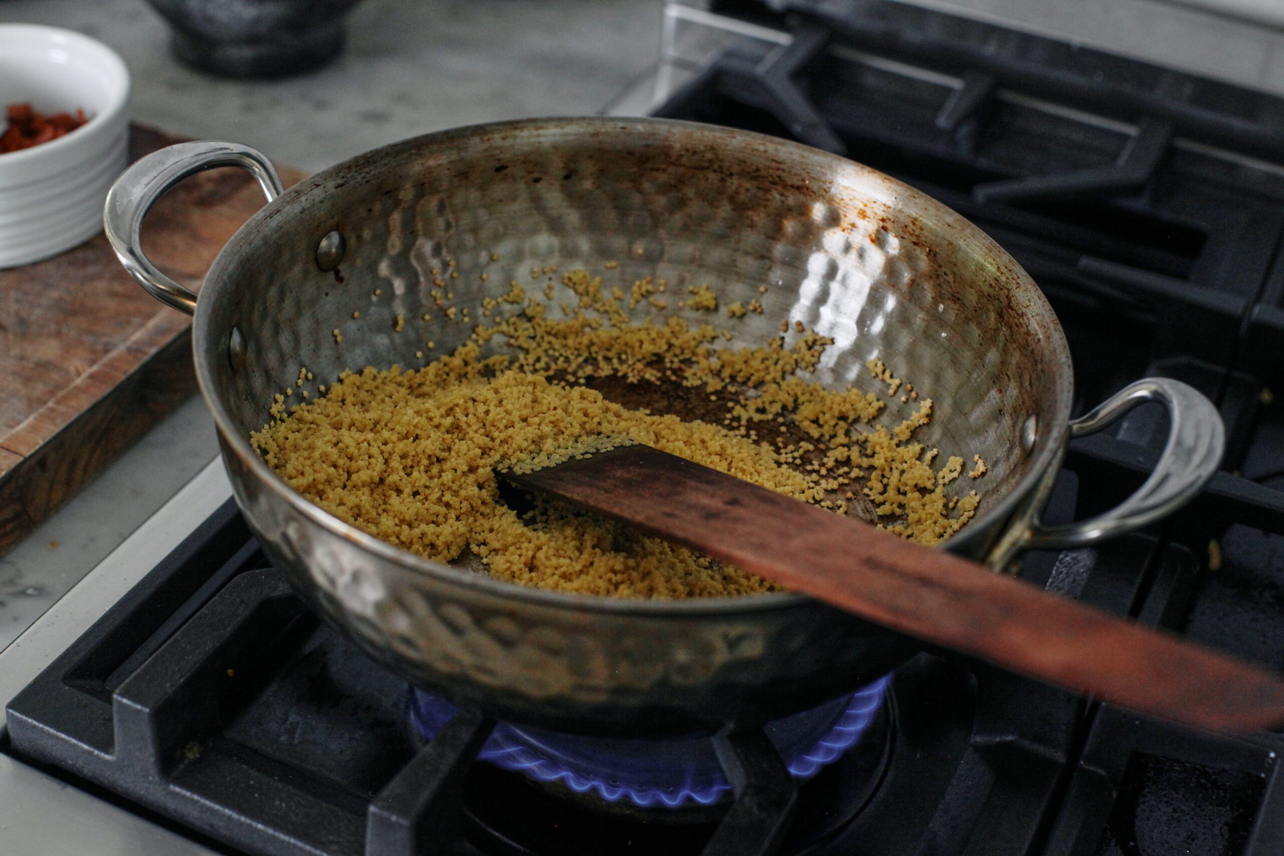 Cheesy Bacon Pastina with Peas 5 pastina toasting in a pan over the stove
