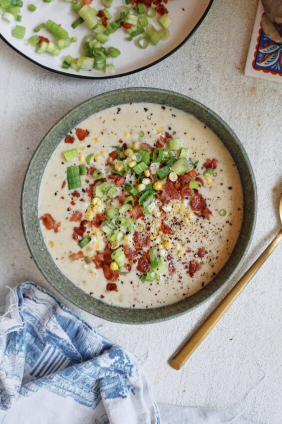 creamy corn chowder topped with green onions, bacon, and black pepper