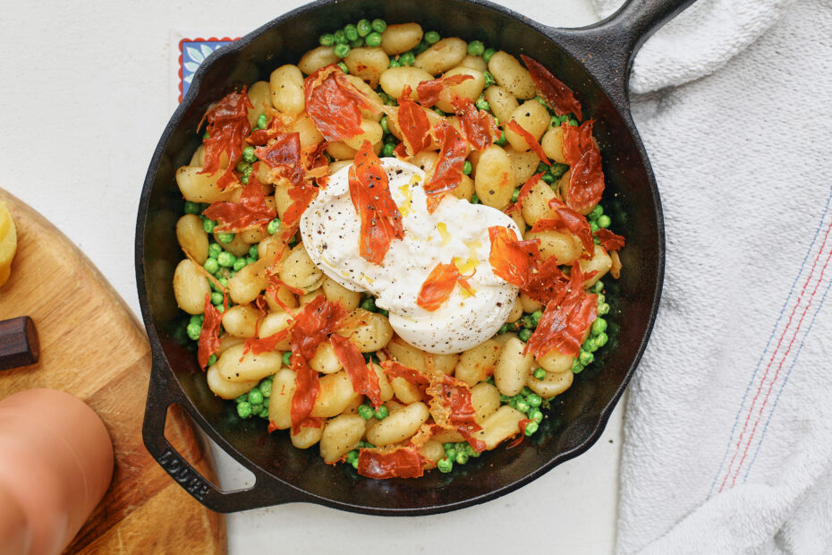 Crispy Gnocchi with Burrata, Peas & Prosciutto in a cast iron skillet