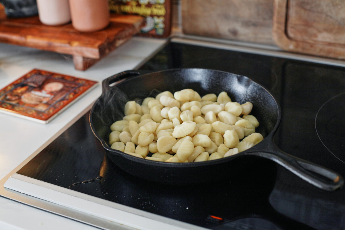 gnocchi in a cast iron skillet on the stovetop