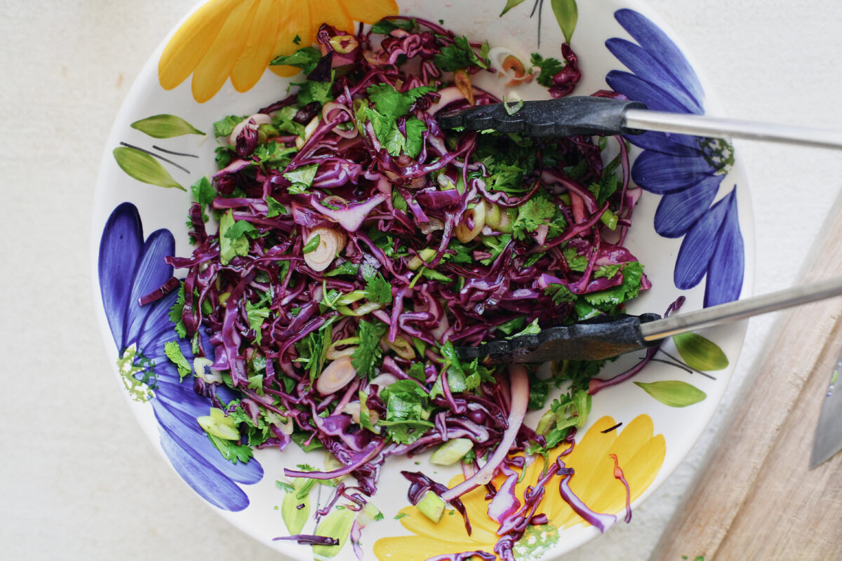 finished slaw: shredded purple cabbage, green onions, cilantro, lime juice, olive oil, maple syrup and a pinch of salt
