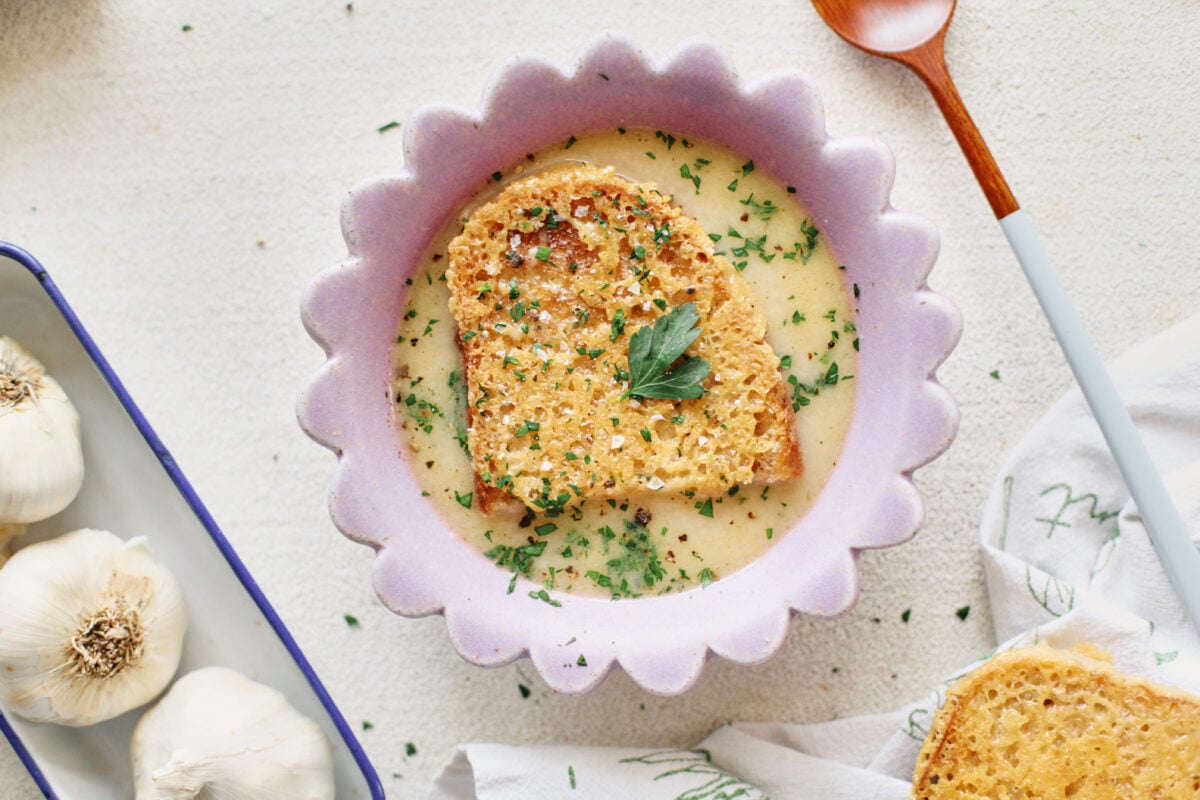 provencal garlic soup topped with a slice of cheesy toast