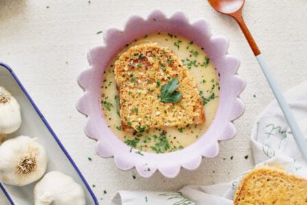 provencal garlic soup topped with a slice of cheesy toast