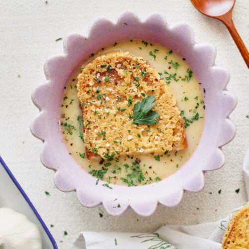 provencal garlic soup topped with a slice of cheesy toast