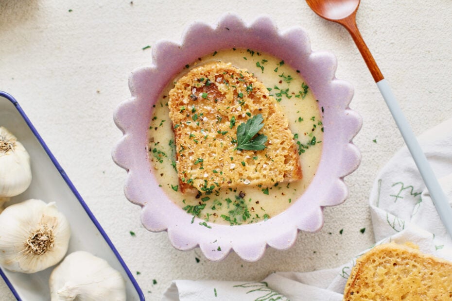 provencal garlic soup topped with a slice of cheesy toast