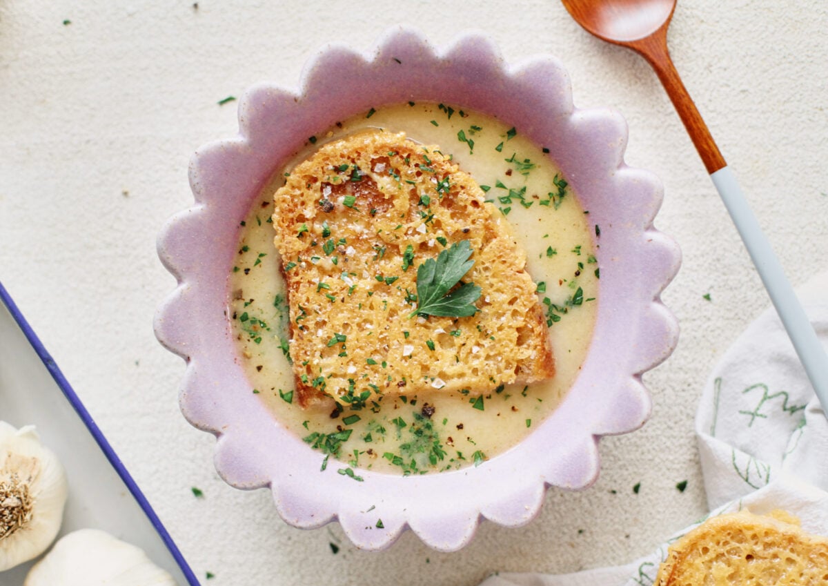 provencal garlic soup topped with a slice of cheesy toast