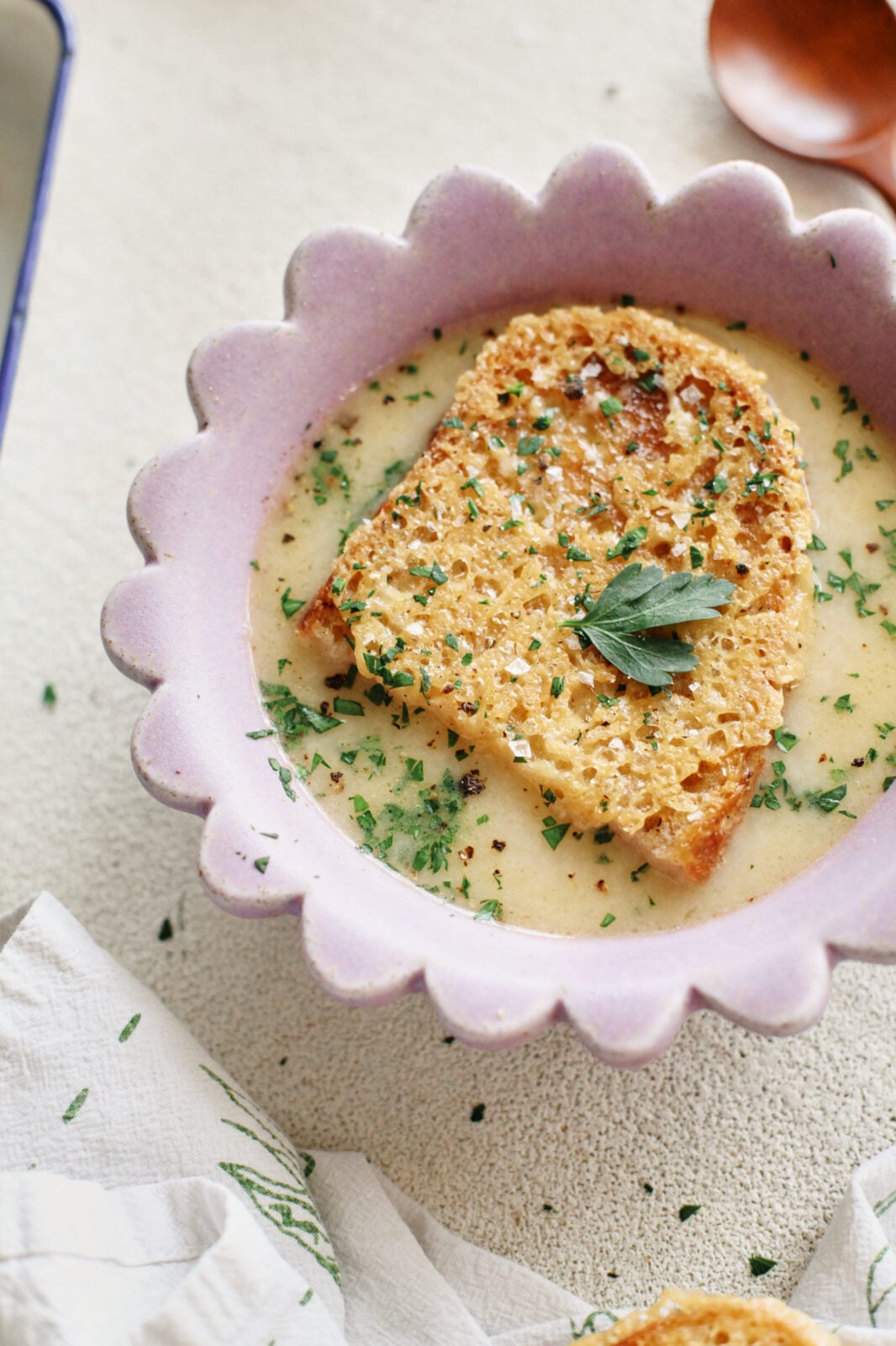 provencal garlic soup topped with a slice of cheesy toast