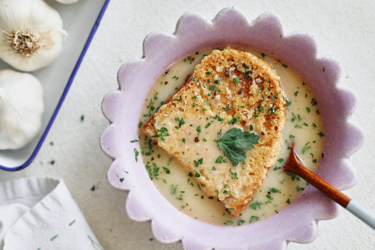 provencal garlic soup topped with a slice of cheesy toast