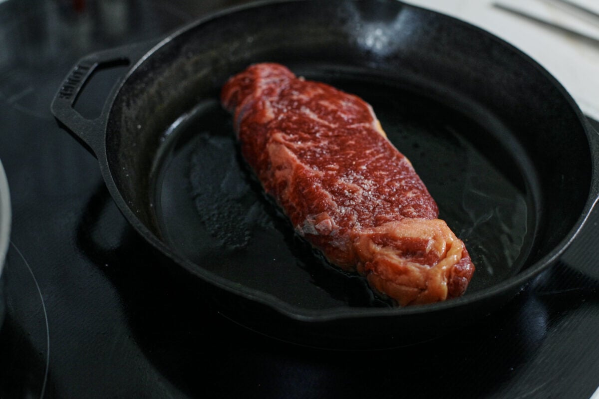 steak searing in a cast iron skillet